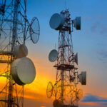 TELCOs Face One-Week Deadline To Propose Data Price Reductions Telecommunication towers with wireless antennas on sunset sky