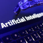 Illustration shows words "AI Artificial Inteligence", keyboard and a robotic hand